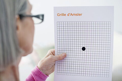Woman testing her vision with Amsler Grid
